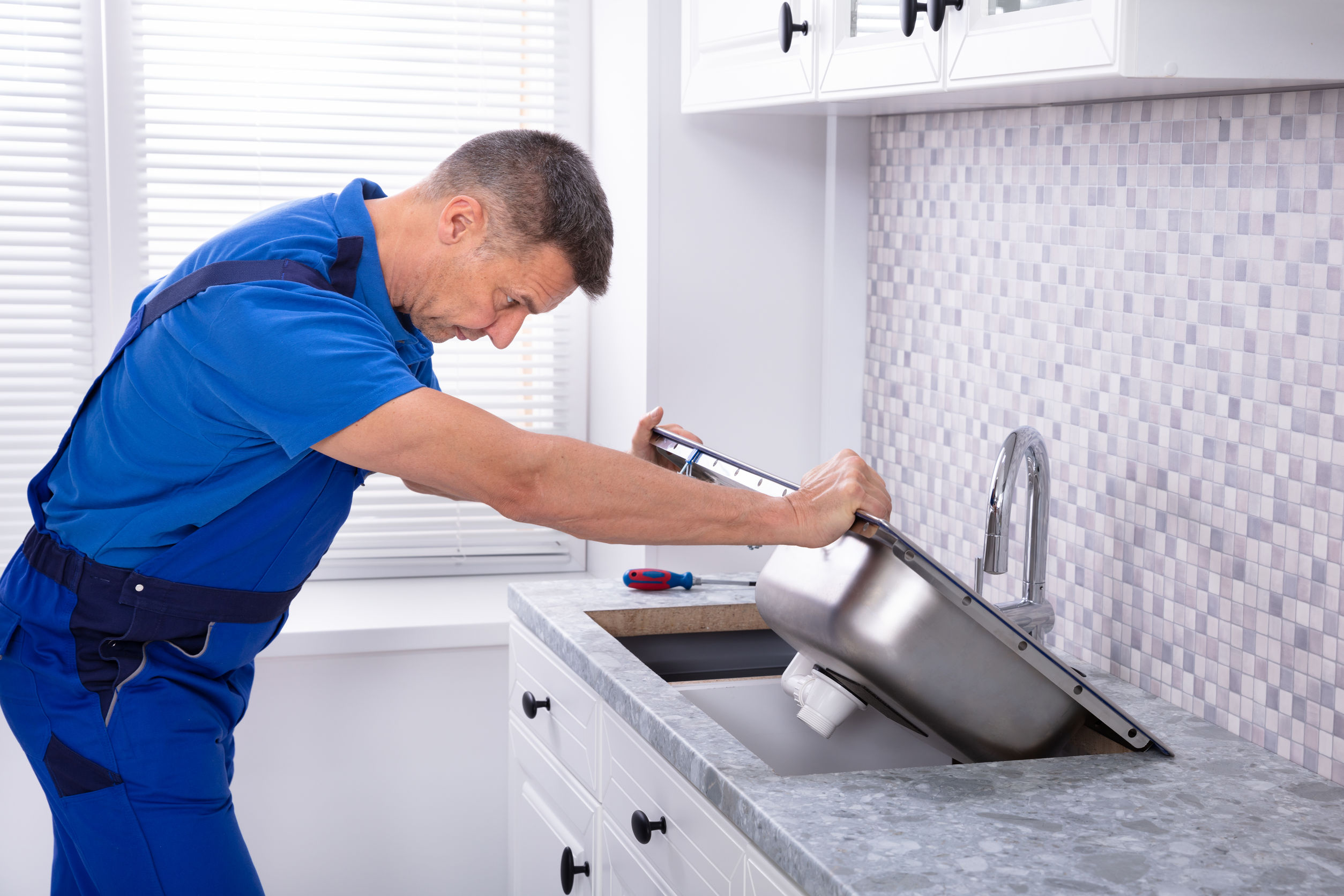 handyman fixing kitchen sink